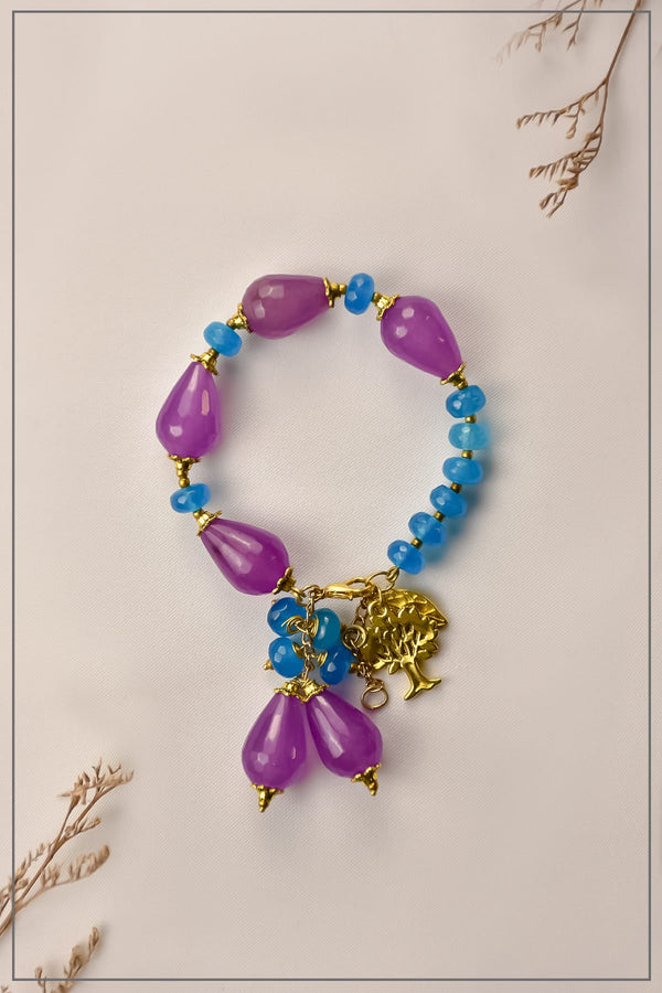 Close-up of Beads Bliss bracelet with purple and blue beads on wrist